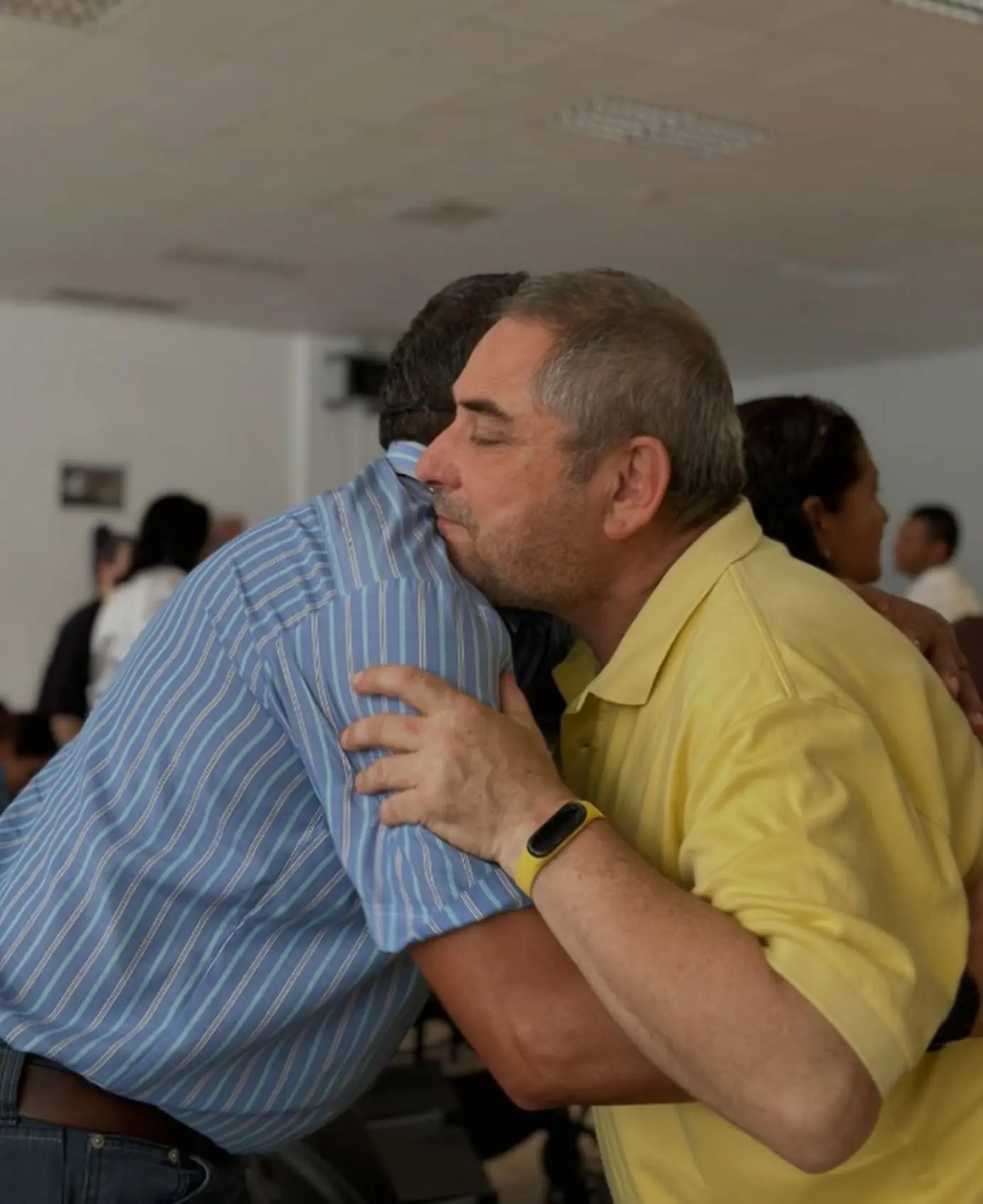 Dos personas se abrazan en la iglesia